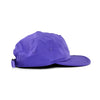 Boné five panel roxo visto de lado, sem estampas, com ajuste traseiro e furos para ventilação no mesmo tom.