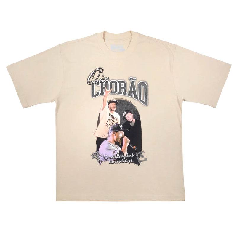 Camisa oversized bege com escrita QIX CHORÃO, com imagens do cantor e frase "Coração vagabundo bate na sola do pé" na parte inferior.