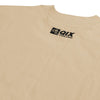 Close do logo próximo à gola na parte de trás da camisa oversized bege.